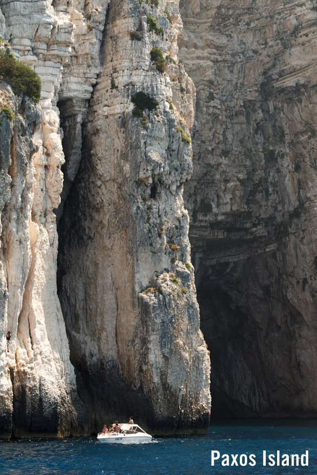 Paxos Island cliffs on the coast with small boat