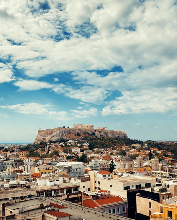 The Athens Greece Acropolis under sunny skies with some clouds