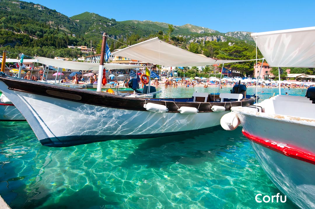 Boat floating upon clear waters at the island of Corfu