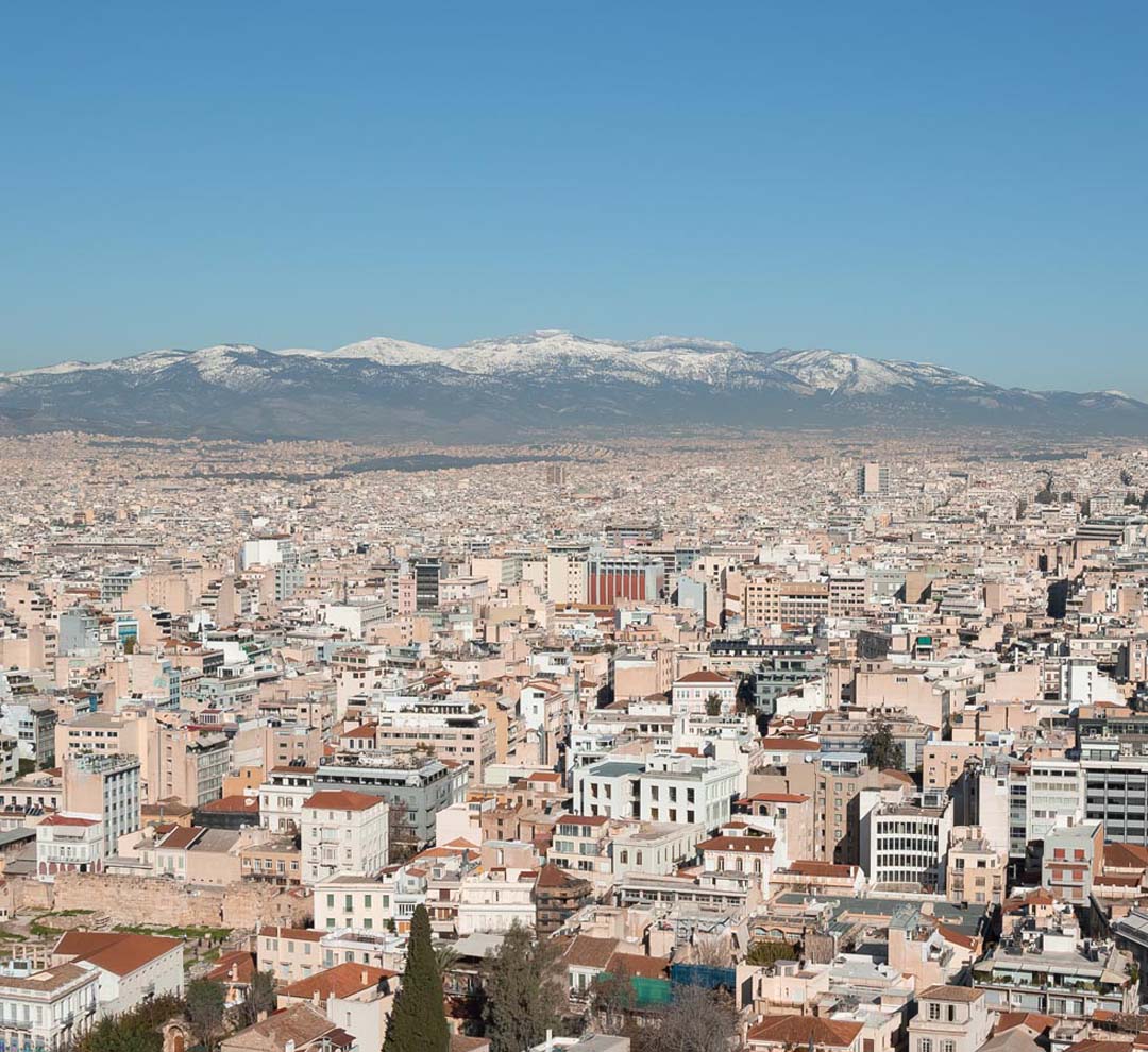 Panoramic of Athens Greece with snow-capped mountains